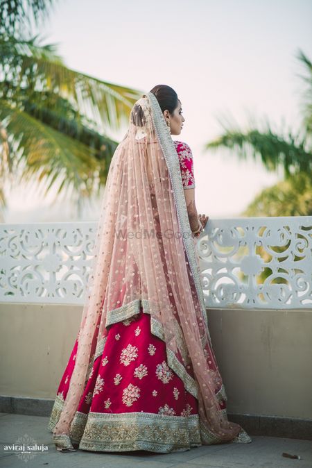 Bride back shot with light pink dupatta