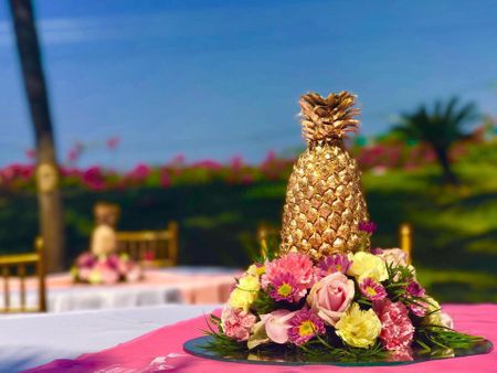 Golden painted pineapple table setting