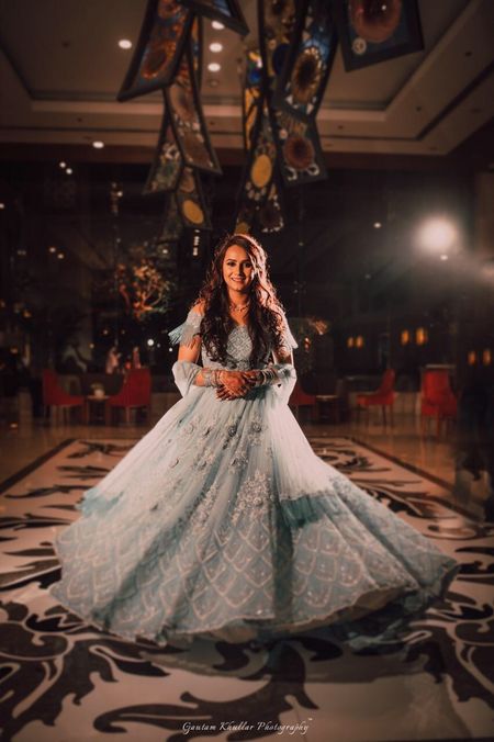 Pretty bride twirling in a pastel blue lehenga