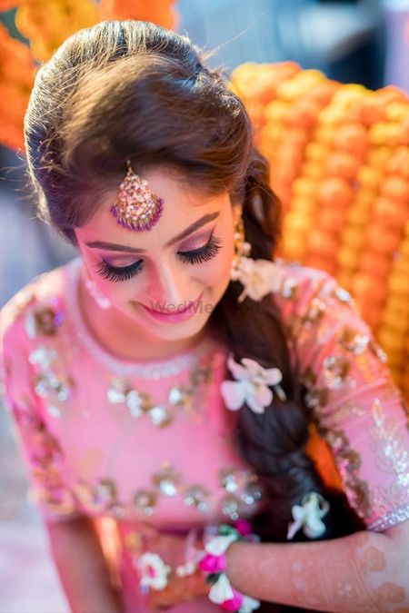 Mehendi look with pink makeup and side braid