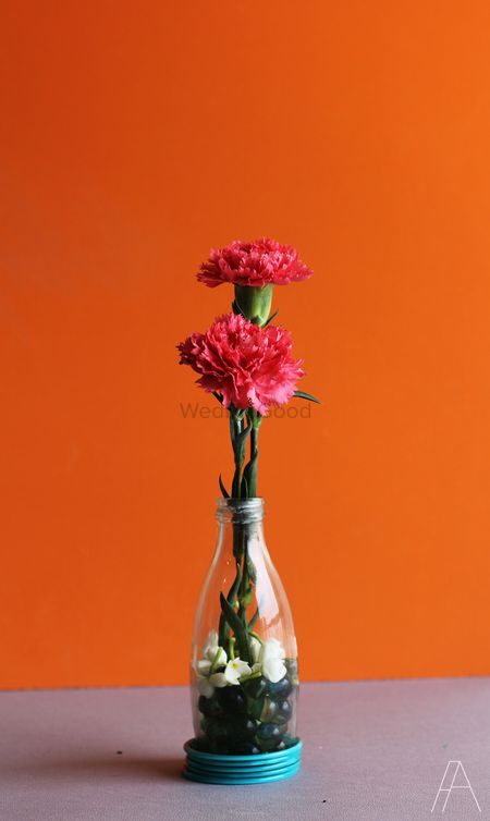 Photo of Table setting with glass bottle and flowers