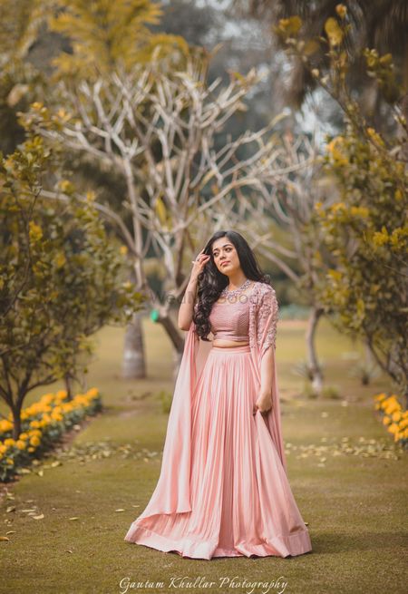 Light peach engagement lehengas with cape sleeves
