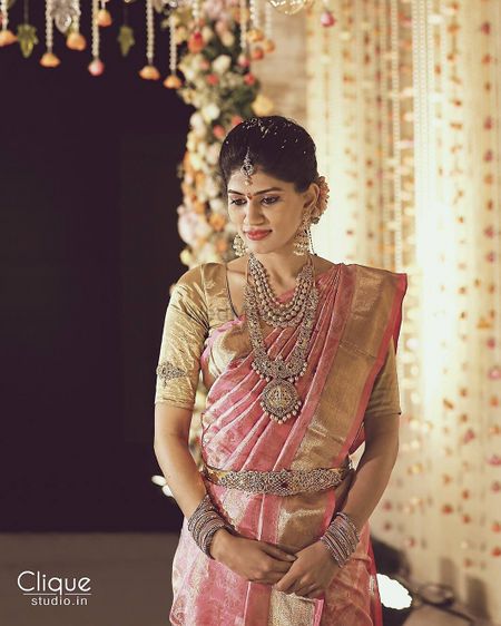 South Indian bride wearing silver jewellery with pink kanjivaram