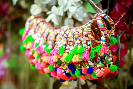 Hanging gota bangles with tassels and pompoms as mehendi favours