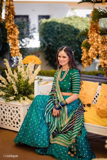 Bride dressed in a teal lehenga for her pre-wedding festivities