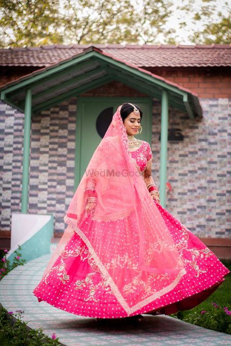 Twirling bride in a Pink lehenga