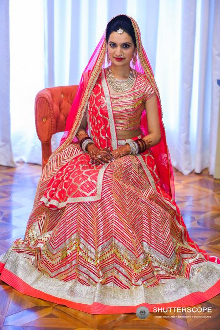Neon pink bridal lehengas with gold and silver work