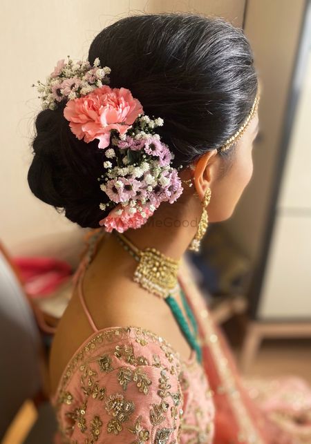 Photo of Beautiful floral bridal bun hairstyle.