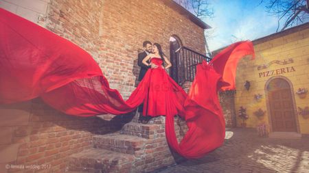 Glam bollywood pre wedding shoot with flowing red gown