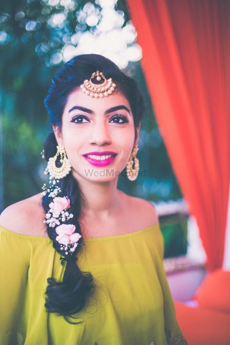 Photo of Side braid with flowers and babys breath in hair for mehendi