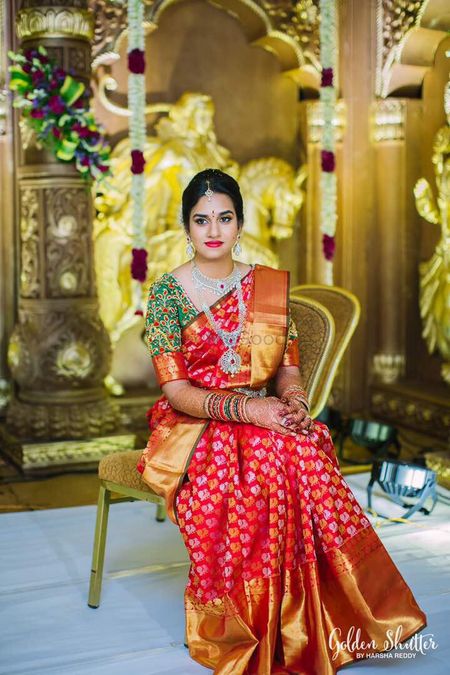 South Indian bride in red kanjivaram and green blouse