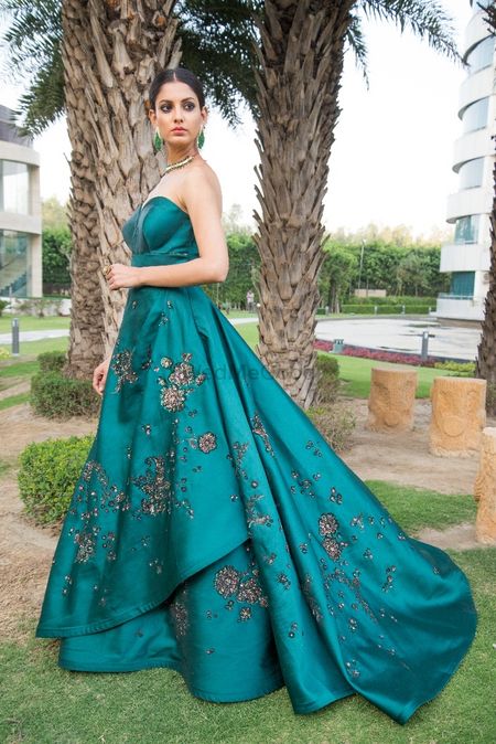 Strapless teal cocktail gown with floral motifs