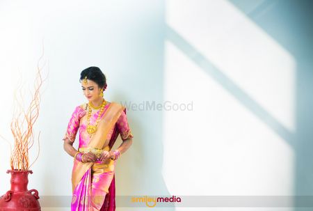 South Indian bridal portrait in pink and gold saree