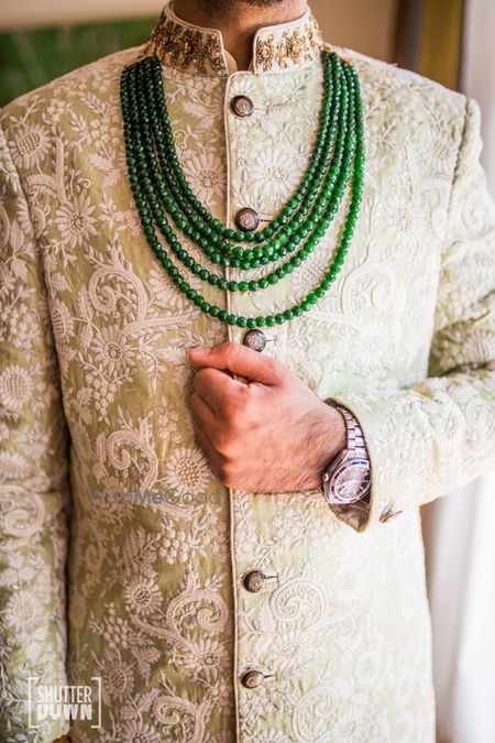 Silver grey floral print sherwani with contrasting necklace