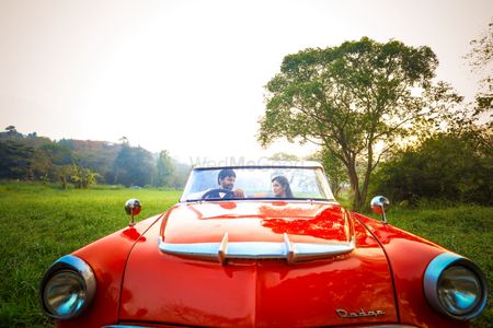 Photo of Pre wedding shoot in red vintage car