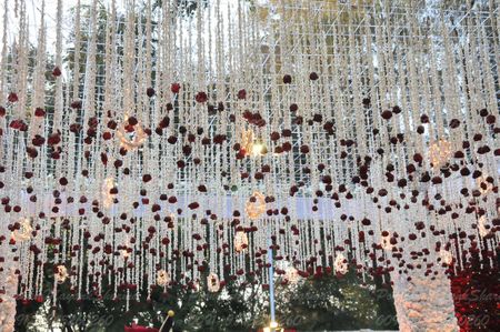 Photo of Hanging white  and red floral strings mandap decor