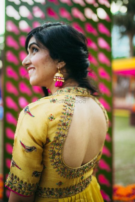Mehendi outfit with aviary inspiration and cutout back