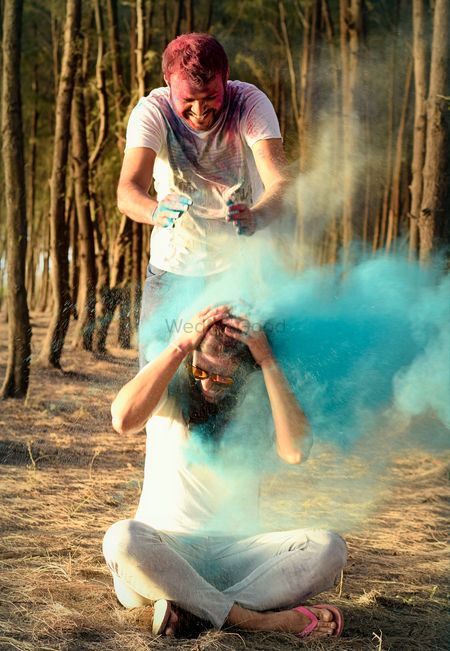 Photo of Holi theme pre wedding shoot idea with couple throwing colours