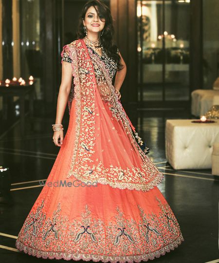 Coral and blue light lehenga with peacock motifs