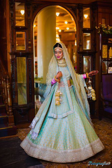 Twirling bride in Mint blue and Gold Lehenga