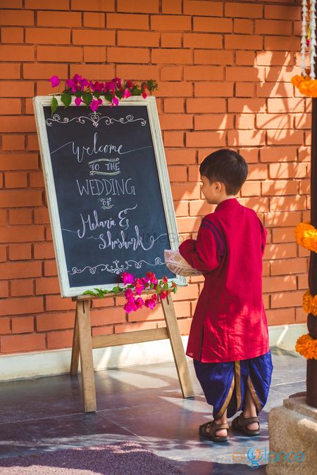 South Indian wedding entrance decor with personalised blackboard quote