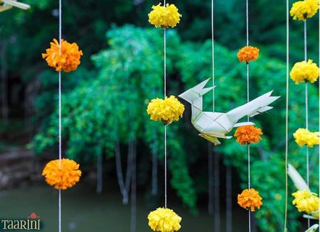 Paper decor bird with genda flower strings