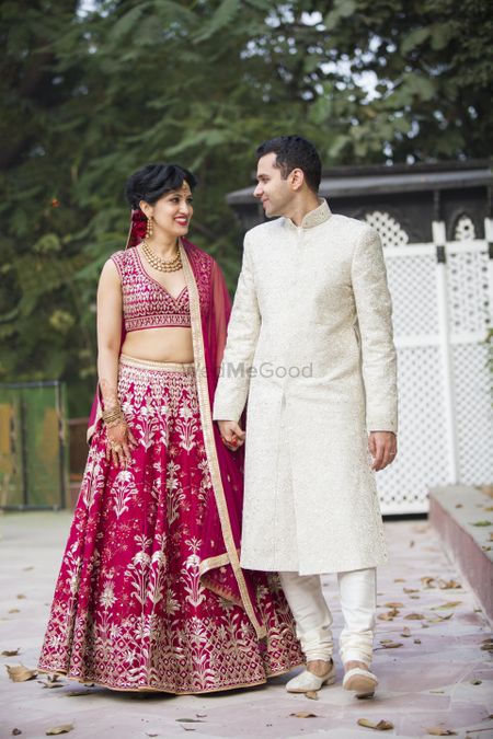 Matching bride and groom with bride in maroon and groom in white