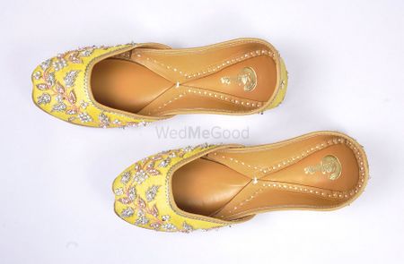yellow juttis with pearl work