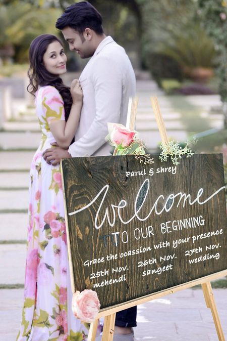 Couple pre wedding shot with invite board!