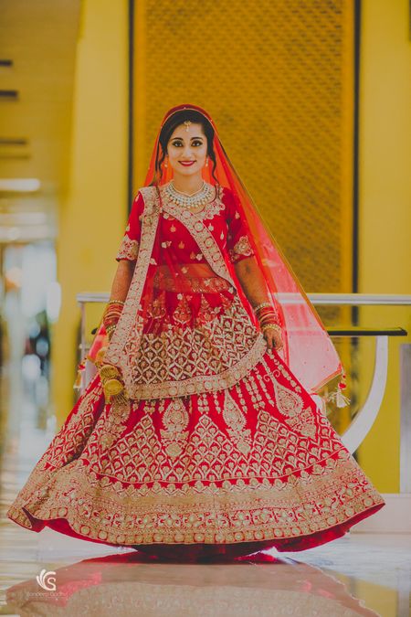 Twirling bride in red and gold