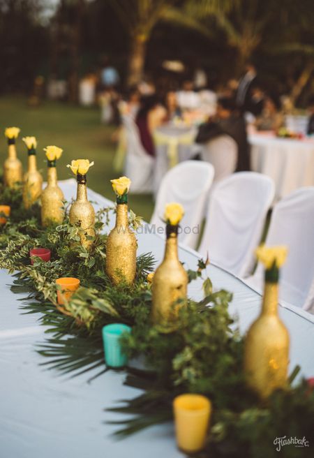 Floral table runner with painted bottles