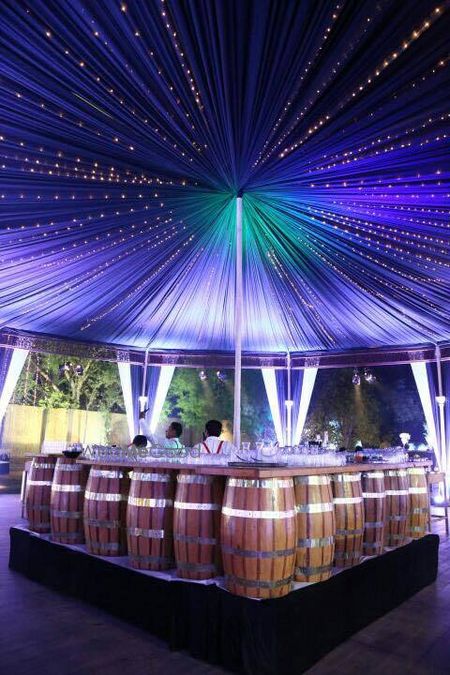 Photo of Bar decor idea with beer barrel props under table