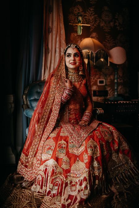 A bride wearing a traditional red lehenga