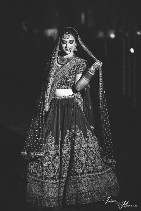 Black and white bridal portrait with bride holding dupatta
