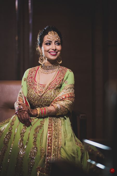 Gold engagement jewellery with layered necklaces and maangtikka
