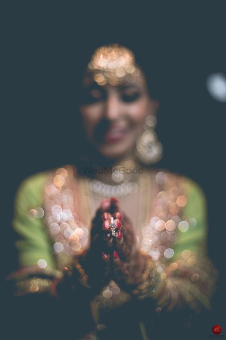 Bride holding engagement ring in focus