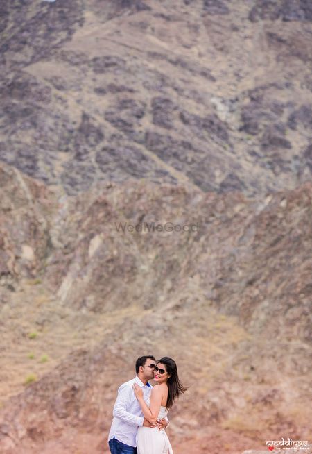 Couple kissing pre wedding shot in the hills