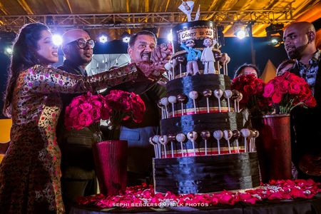 Photo of Quirky black wedding cake with lollipops