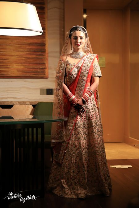 Light pink bridal lehenga with contrasting red double dupatta