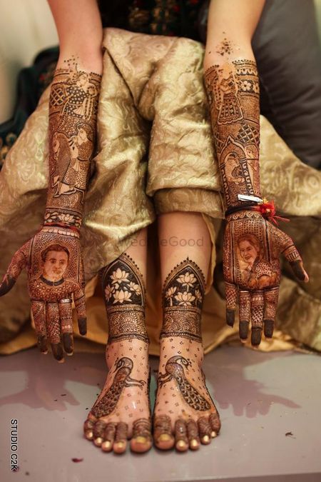 Photo of Hand mehendi with portraits and feet with peacock motifs