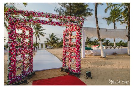 Unique entrance decor with floral doorway for beach wedding