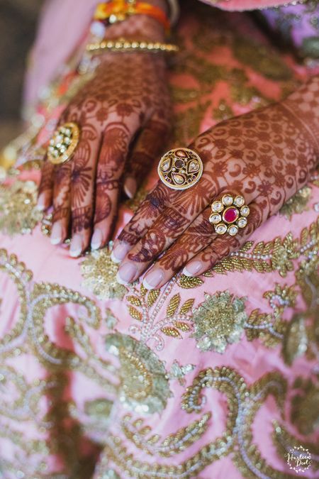 Bridal hands with rings and mehendi