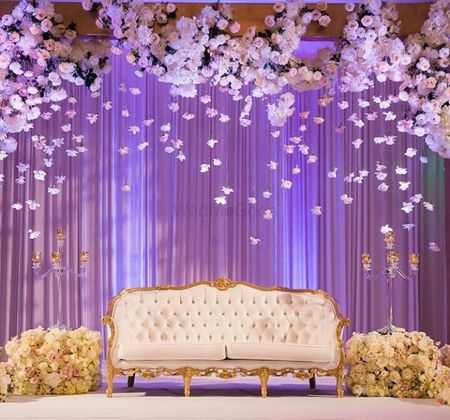 Photo of Elegant stage backdrop with hanging floral strings in white