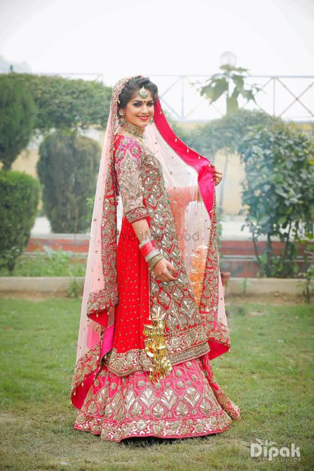 Sikh bride wearing red and pink lehenga with kurta