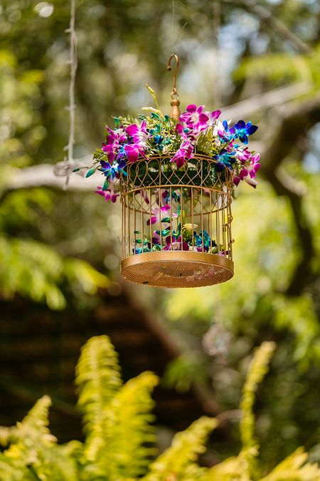 Hanging floral arrangement in gold birdcage