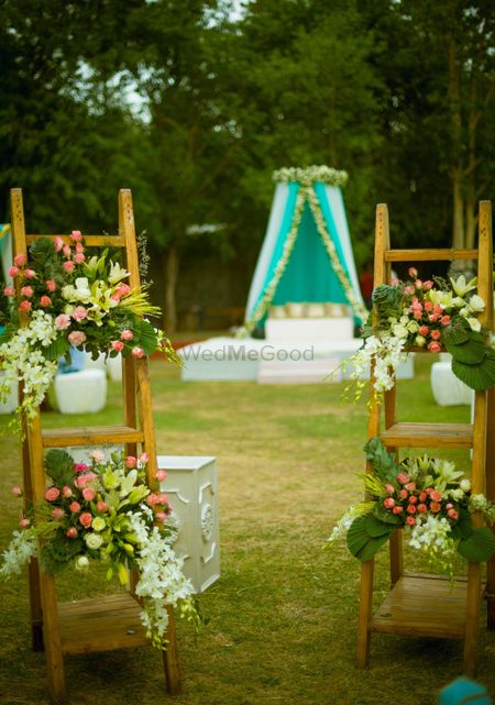 Wooden ladder with floral arrangements in decor