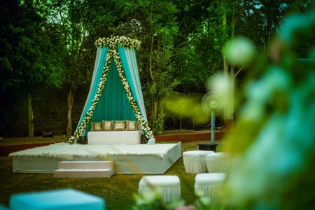 Mehendi seating with mint blue drapes and floral arrangements