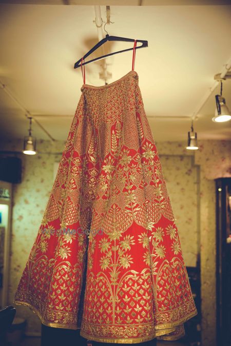 Red and gold hanging lehenga shot