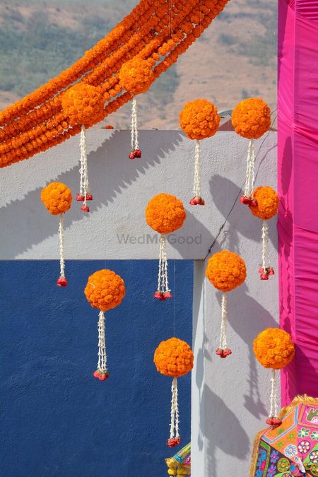 Photo of Hanging mehendi decor idea with genda phool balls