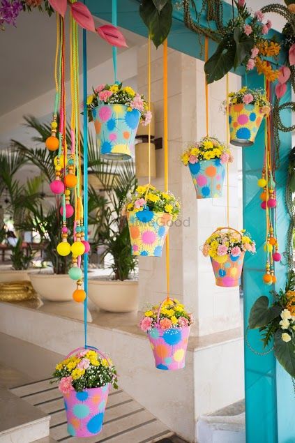 Colorful hanging buckets with flowers in decor